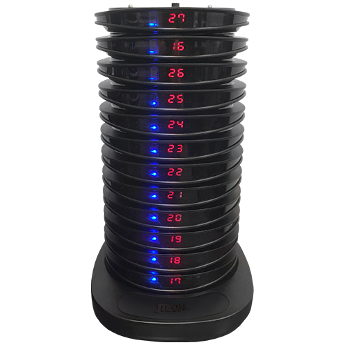 The side view of a JTECH charging rack, displaying a variety of pager numbers and a singular blue light next to each number.