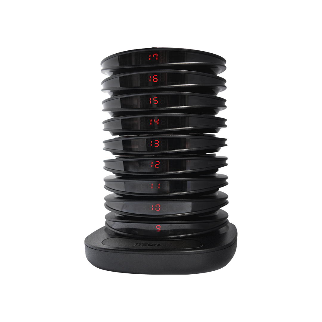 The side view of a JTECH charging rack displaying a variety of pager numbers.